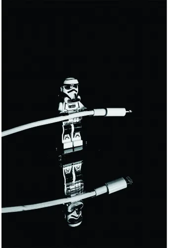 Two action figures of stormtroopers holding glowing lightsabers crossed against each other on a black background.