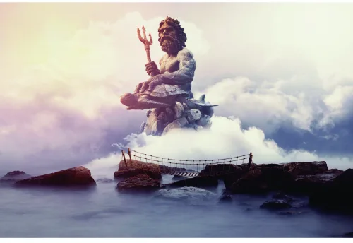 A woman in flowing robes sits meditating on rocks surrounded by clouds and misty seascape.