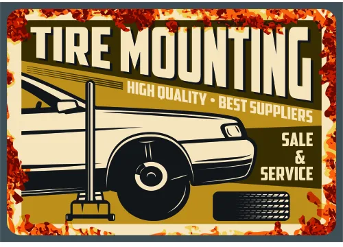 A vintage-style metal sign advertising tire mounting services in cream, gold and black with a weathered rust-coloured border.
