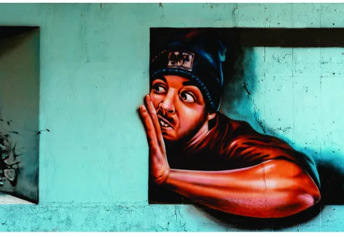 Street art portrait of a person with hand to face in red and black against a distressed turquoise wall.