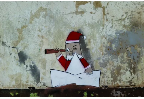 A cartoon Santa in red and white with a telescope, studying a large unfolded map beneath him against a weathered grey wall.