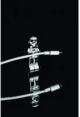 Two action figures of stormtroopers holding glowing lightsabers crossed against each other on a black background.