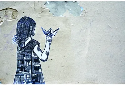 A stencilled line drawing of a girl with long hair, rendered in navy blue, holding up a star on a cream-coloured weathered concrete background.