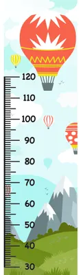 A height measurement chart showing hot air balloons in red, orange and yellow floating above a landscape of green fields and grey mountains, with measurement markings from 30 to 120 centimetres.